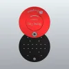 Red top disc with a rotating mechanism over a black circular base, against a gray gradient background.