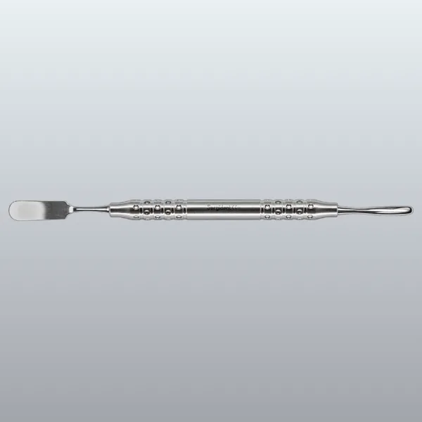 Stainless steel dental spatula with a knurled grip, used to mix or apply dental materials, shown horizontally on a gray gradient background