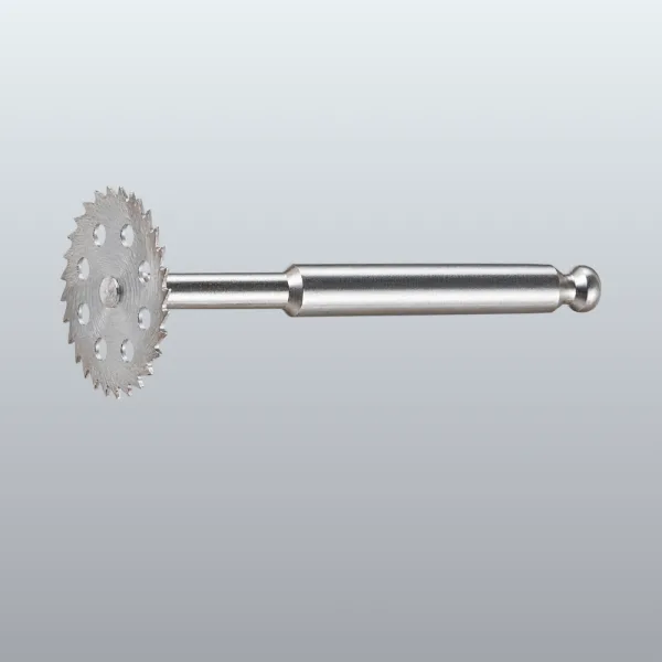 Metal gear-like wheel with sharp teeth mounted on a long metal shaft with a rounded end.